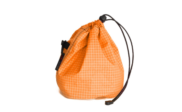A Medium, clear-bottomed Yarn Stuff Sack in Zest (orange with white grid) 200 Halcyon.